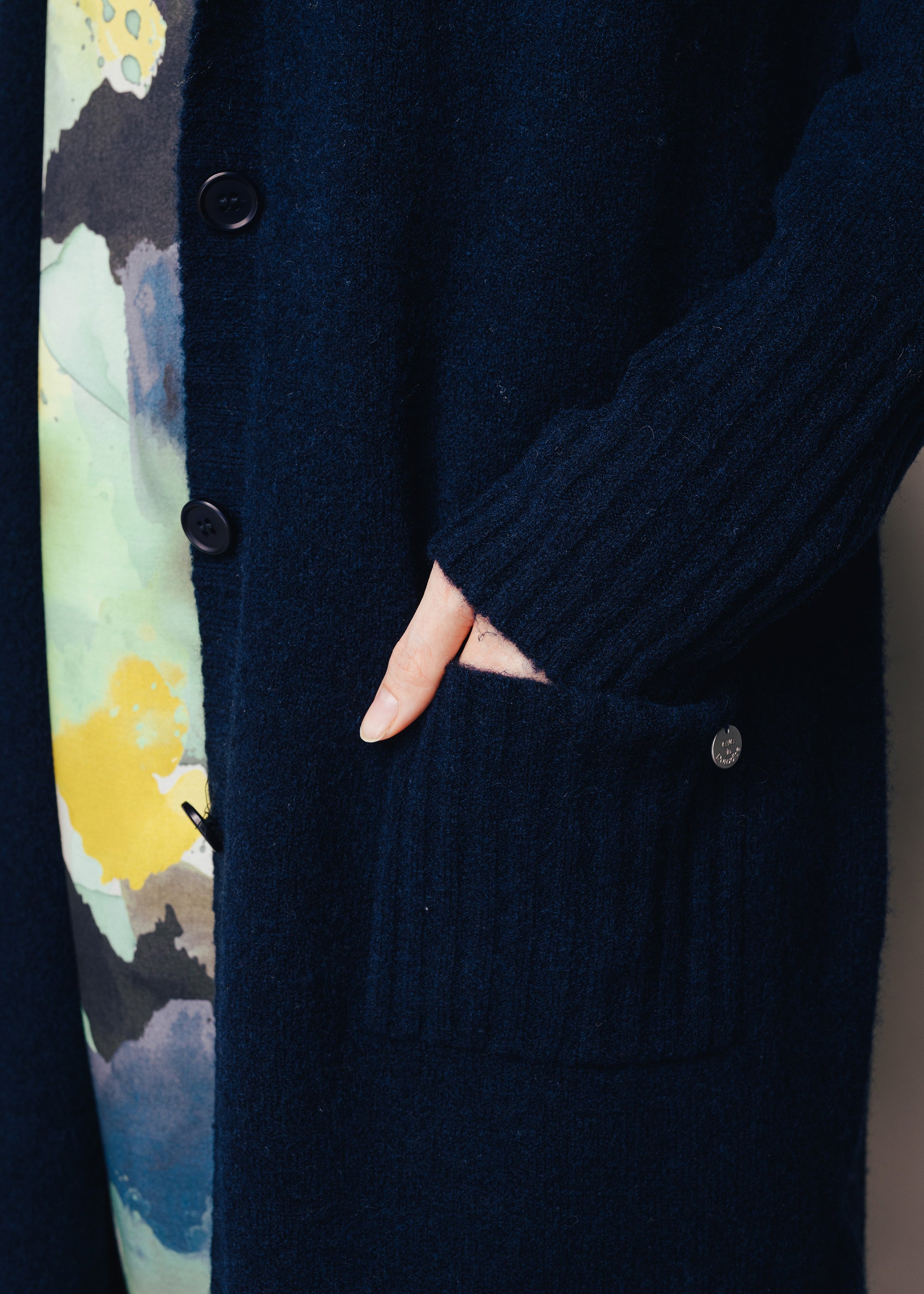 Long knitted coat with hood made of wool mix